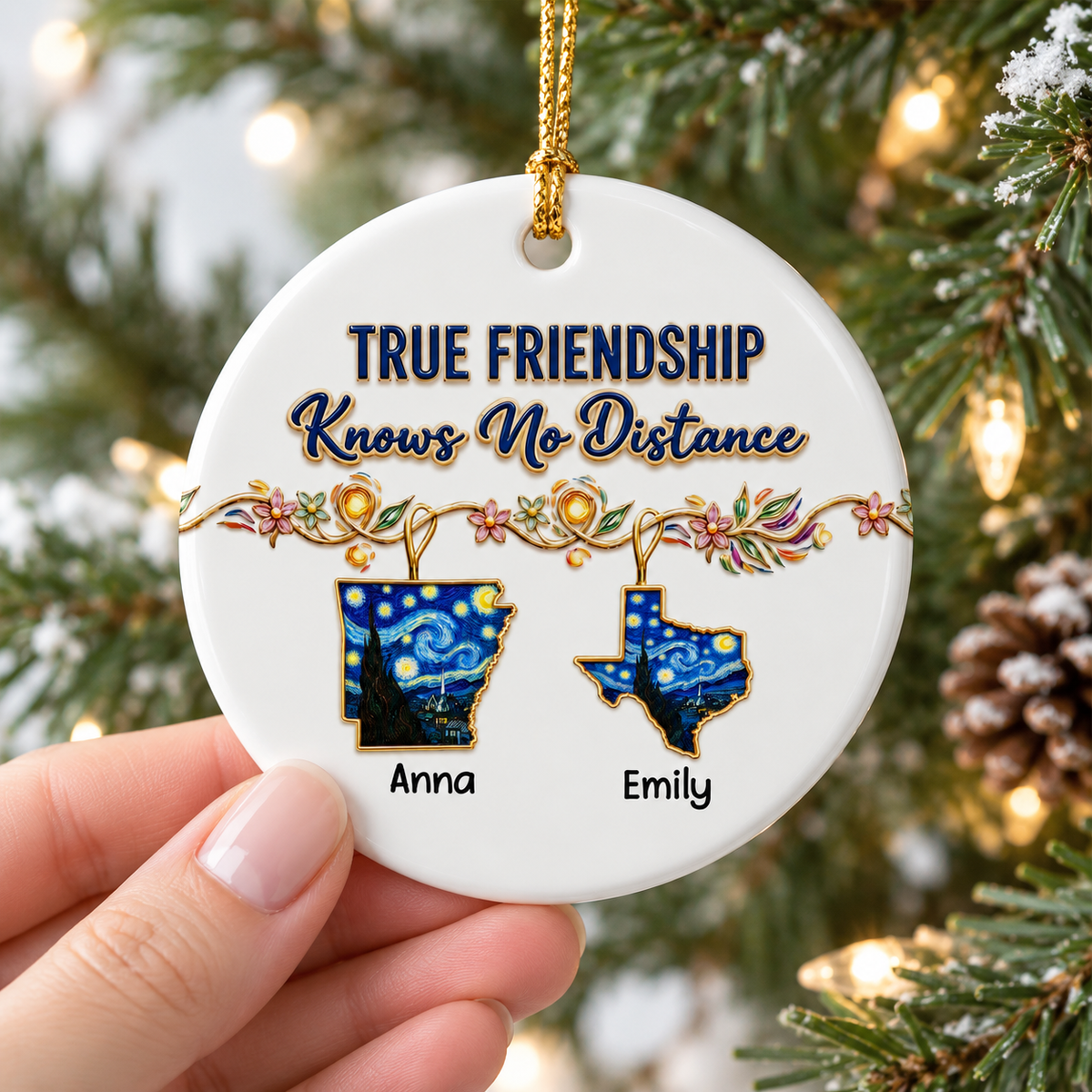 Hand holding a round ceramic ornament featuring Starry Night state silhouettes against a decorated Christmas tree background.