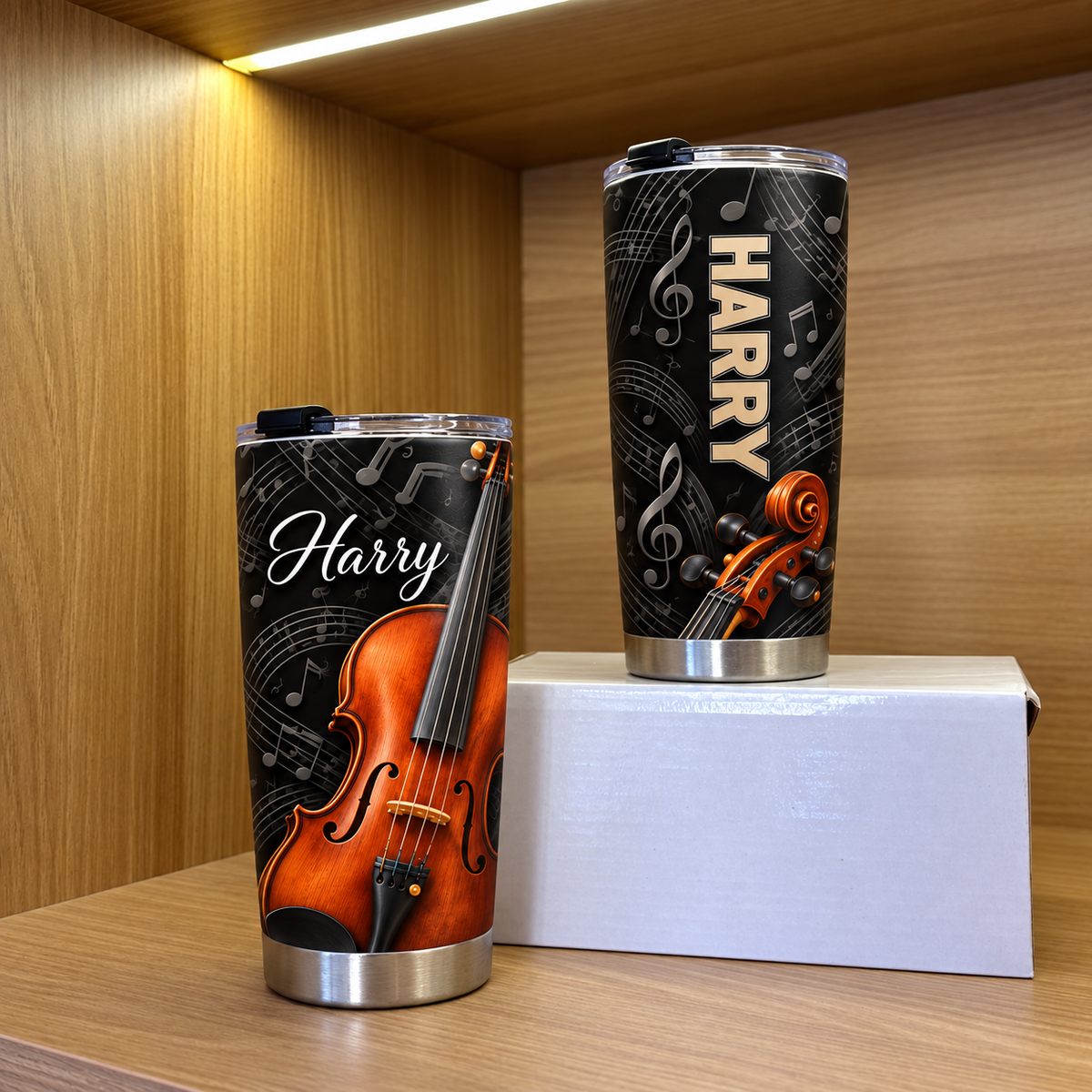 Two personalized violin tumblers displayed on wooden shelves, showing different angles of the custom name print.