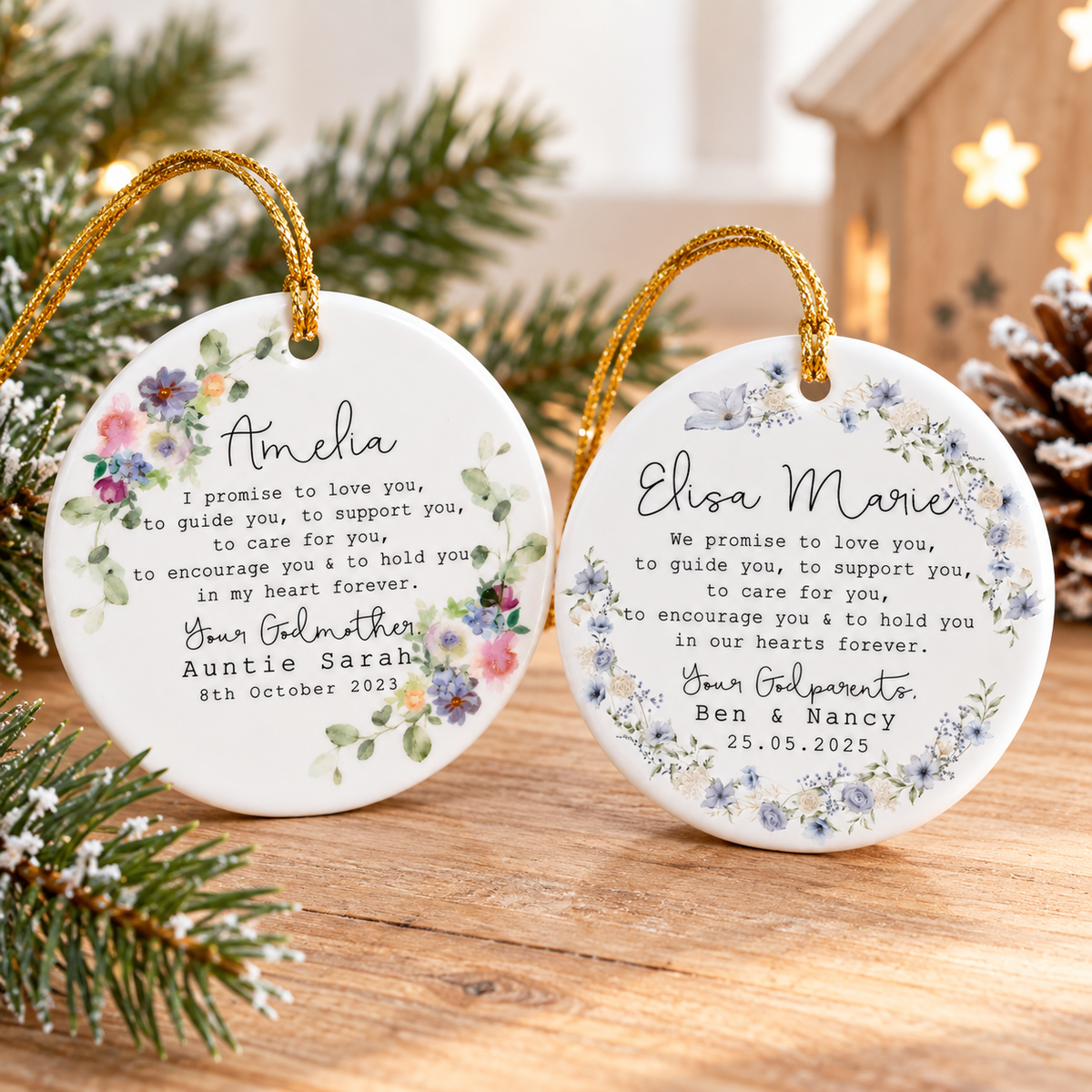 Two round ceramic ornaments with watercolor floral wreaths displayed upright on wood.