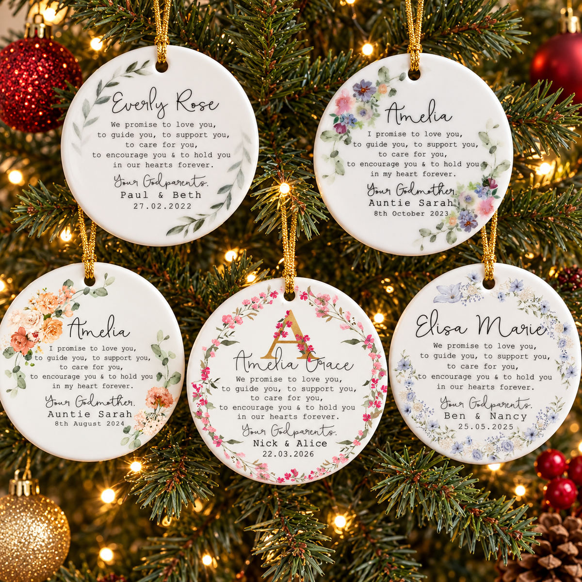 Five personalized ceramic ornaments with watercolor floral designs hanging on a decorated Christmas tree.