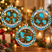 Three round acrylic state map ornaments hanging against a holiday lights backdrop, showing different designs.