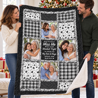 Man and woman holding up a long distance relationship quilt with a black and white patchwork design and photo panels.