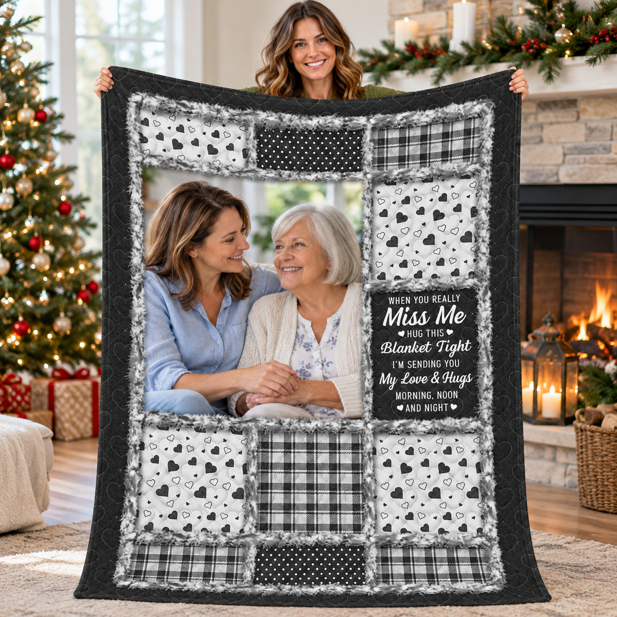 A woman holds up a black and white patchwork blanket featuring hearts, plaid, polka dots, and a sentimental missing you