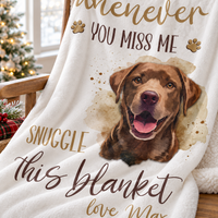 A white comfort blanket for grief draped over a wooden rocking chair next to holiday decor.