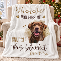 A plush white dog memorial blanket folded neatly on an armchair in front of a decorated holiday tree.