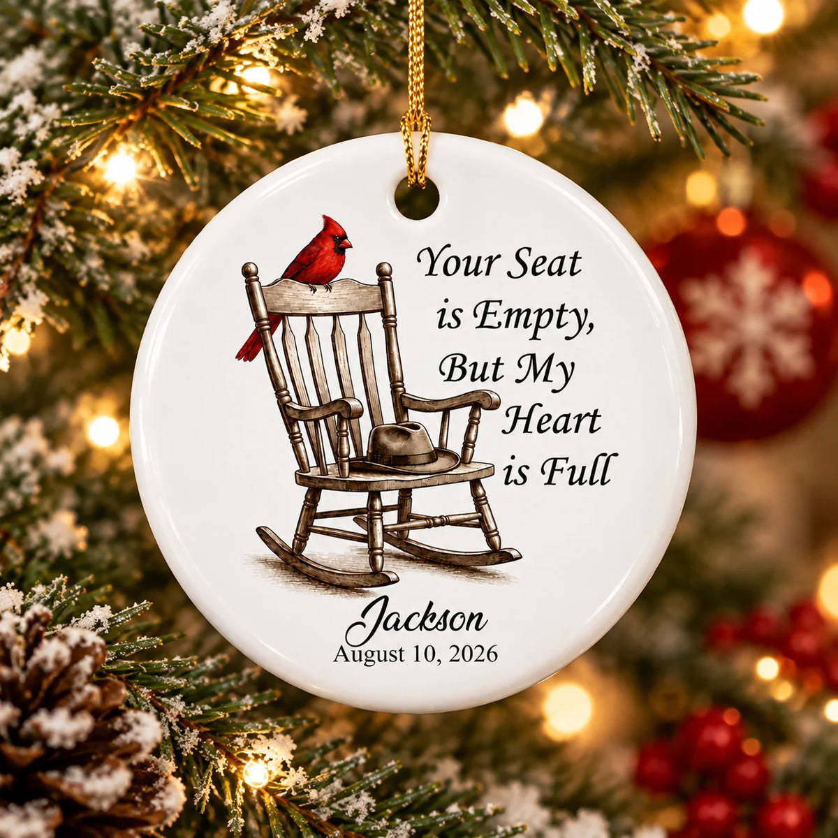 Personalized memorial ornament hanging on a lit Christmas tree with custom name Jackson and date.